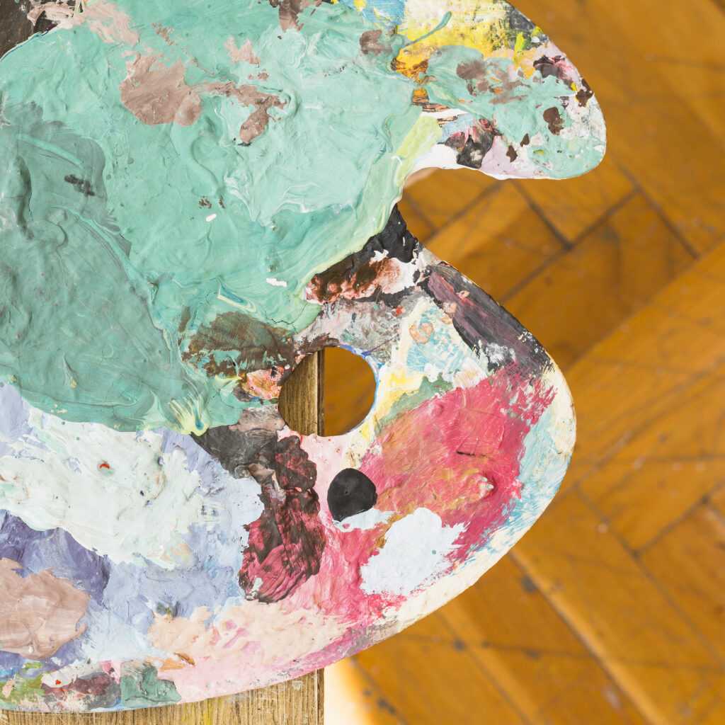 top view messy oil paint wooden palette